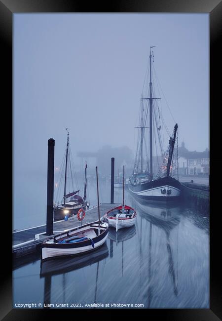 Boats moored in the harbour in fog at dawn. Wells-next-the-sea, Framed Print by Liam Grant