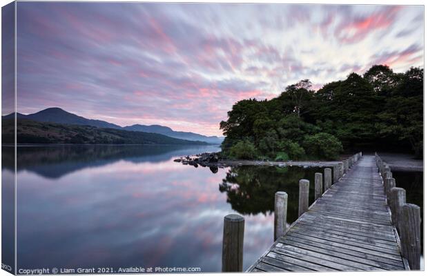 Jetty and reflections on the surface of Coniston Water at dawn. Canvas Print by Liam Grant
