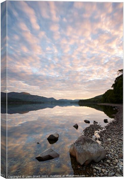 Reflections on the surface of Coniston Water at sunrise. Cumbria Canvas Print by Liam Grant