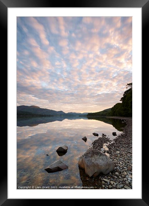 Reflections on the surface of Coniston Water at sunrise. Cumbria Framed Mounted Print by Liam Grant