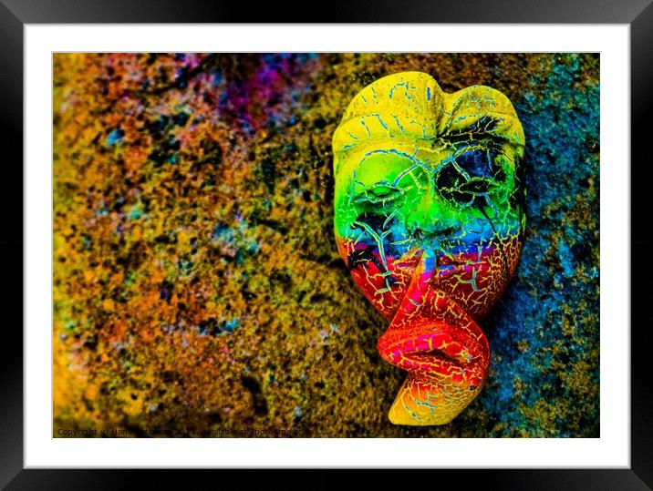 A Bali face mask with finger on its mouth. Framed Mounted Print by Hanif Setiawan