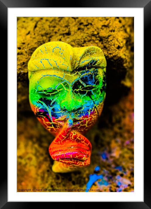 A Bali face mask with finger on its mouth. Framed Mounted Print by Hanif Setiawan