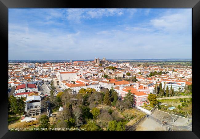 Evora drone aerial view on a sunny day with historic buildings city center and church in Alentejo, Portugal Framed Print by Luis Pina