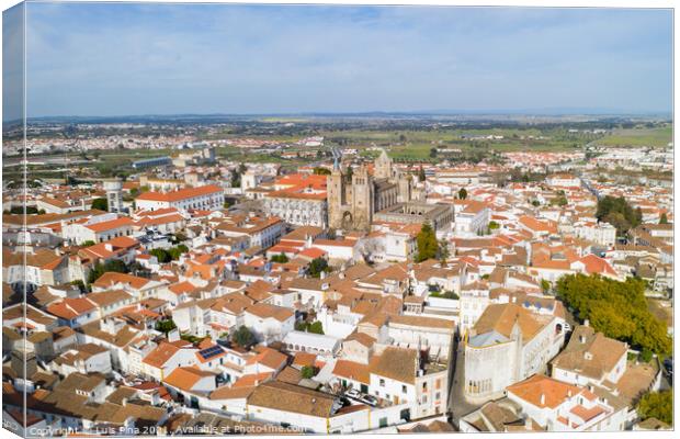 Evora drone aerial view on a sunny day with historic buildings city center and church in Alentejo, Portugal Canvas Print by Luis Pina