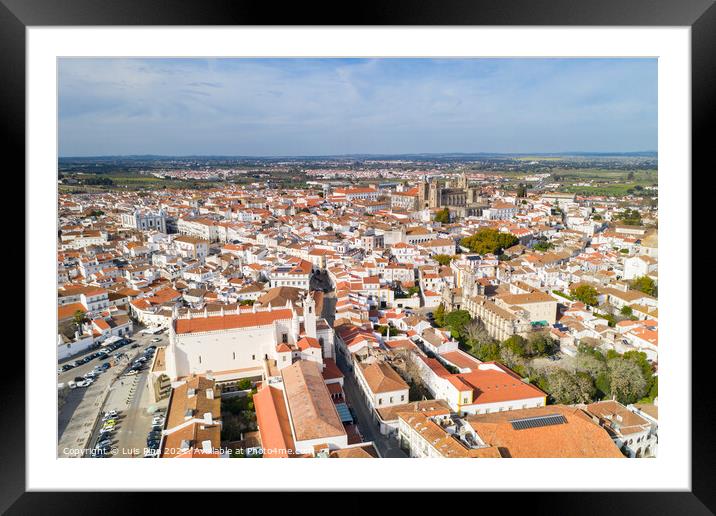 Evora drone aerial view on a sunny day with historic buildings city center and church in Alentejo, Portugal Framed Mounted Print by Luis Pina
