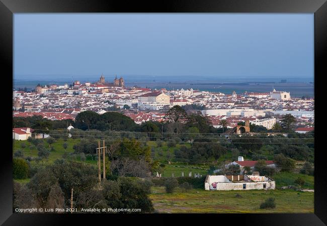 Evora city historic buildings and church view at sunset from a viewpoint on the outside in Alentejo, Portugal Framed Print by Luis Pina