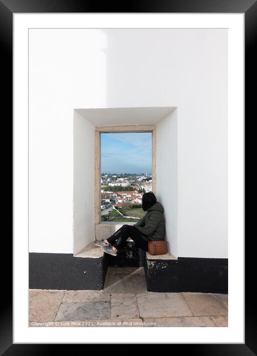 Woman girl traveler sit and looking through a white wall window Estremoz city and Alentejo landscape, in Portugal Framed Mounted Print by Luis Pina