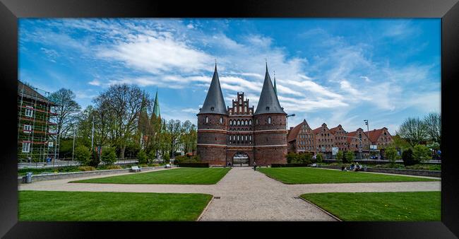 Famous Holsten Gate in the city of Lubeck Germany - CITY OF LUBECK, GERMANY - MAY 10, 2021 Framed Print by Erik Lattwein