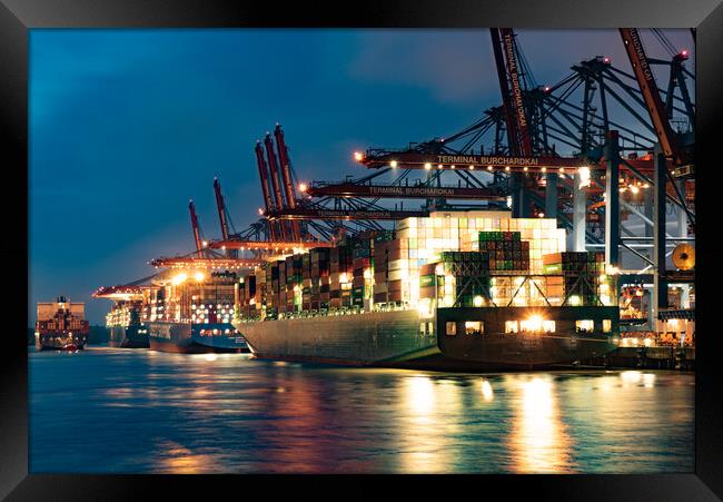 Port of Hamburg with its huge container terminals by night - CITY OF HAMBURG, GERMANY - MAY 10, 2021 Framed Print by Erik Lattwein