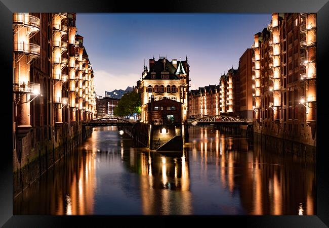 Historic warehouse district in the city of Hamburg by night - CITY OF HAMBURG, GERMANY - MAY 10, 2021 Framed Print by Erik Lattwein