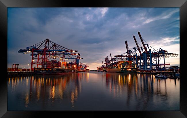 Port of Hamburg in the evening in the back light - CITY OF HAMBURG, GERMANY - MAY 10, 2021 Framed Print by Erik Lattwein