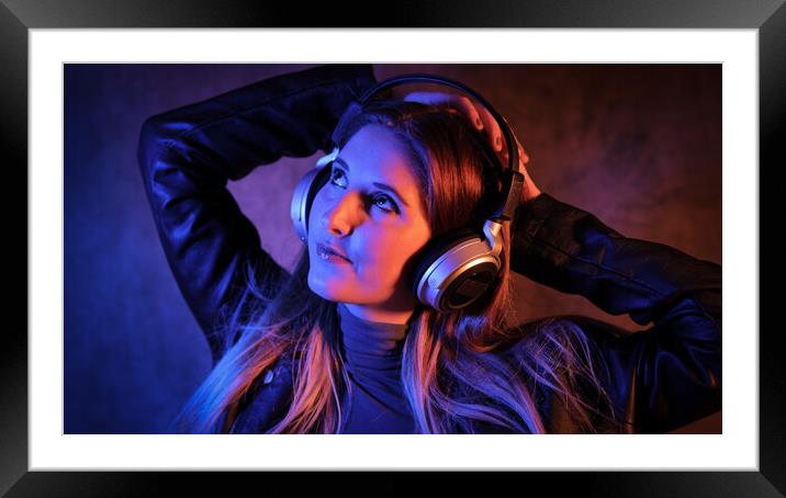 Young pretty woman listens to music - strong colorful close-up shot Framed Mounted Print by Erik Lattwein