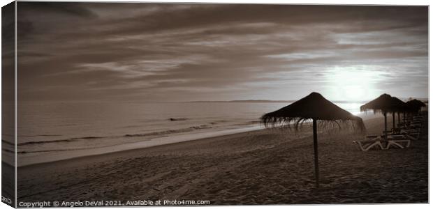 Sunset and umbrellas in Garrao - Algarve Canvas Print by Angelo DeVal