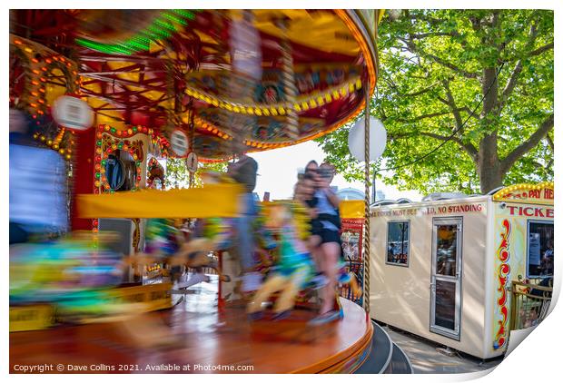 Fairground carousel ride blurred to show speed and movement with small child watching, London UK Print by Dave Collins