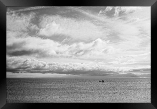 Lone Boat Under Cloudy Sky Framed Print by Rob Cole