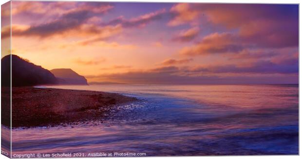Serene Sunrise at Charmouth Beach Canvas Print by Les Schofield