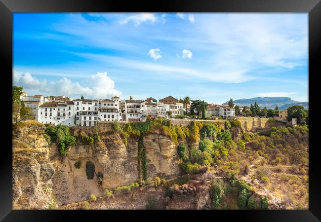 Famous Ronda restaurants and colonial houses overlooking the scenic gorge and the Puente Nuevo bridge Framed Print by Elijah Lovkoff