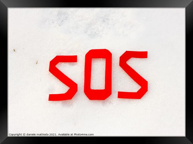 the word sos on a snowfield Framed Print by daniele mattioda