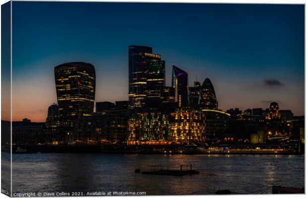 City of London Financial District buildings illuminated at dusk from the south bank walkway by Tower Bridge in London, UK Canvas Print by Dave Collins