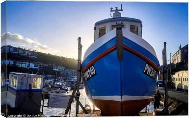 Fishing boat docked in Mevagissey Harbour, Cornwall, England. Canvas Print by Gordon Maclaren