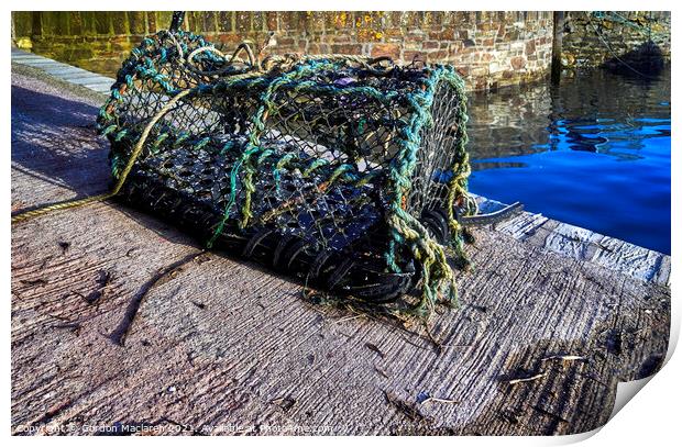 Lobster pot on the quay in Mevagissey Harbour Print by Gordon Maclaren