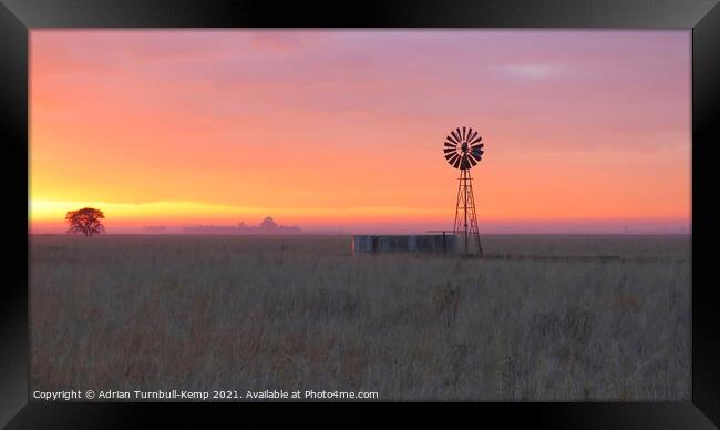 Sunrise over wind pump Framed Print by Adrian Turnbull-Kemp