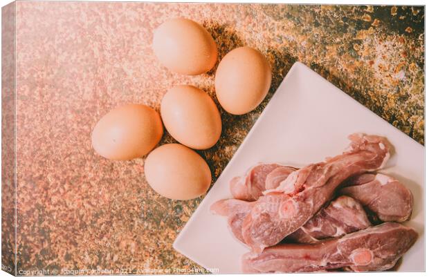 Healthy foods rich in animal protein, raw meat and eggs. Canvas Print by Joaquin Corbalan