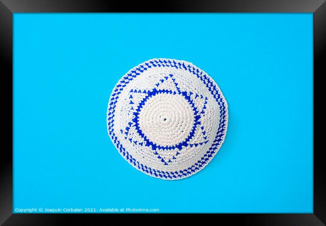 Kippah is a circular hat, with the flag of Israel, isolated on a Framed Print by Joaquin Corbalan