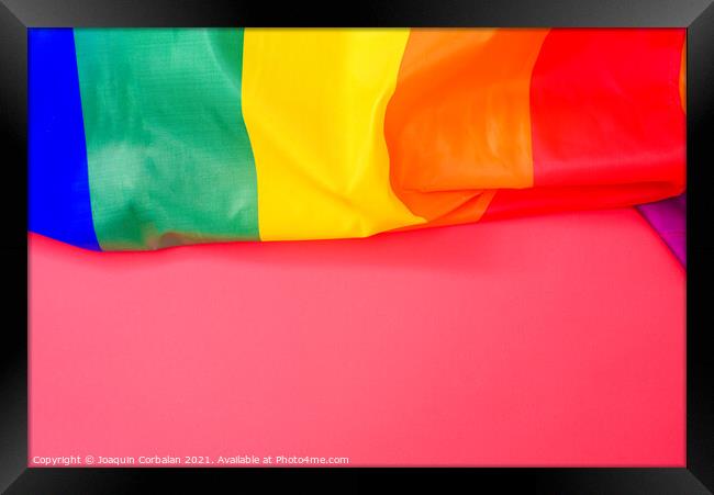 Red background with space for text, with the rainbow flag of the Framed Print by Joaquin Corbalan