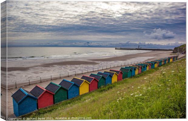 Whitby Beach huts waiting for the storm Canvas Print by Richard Perks