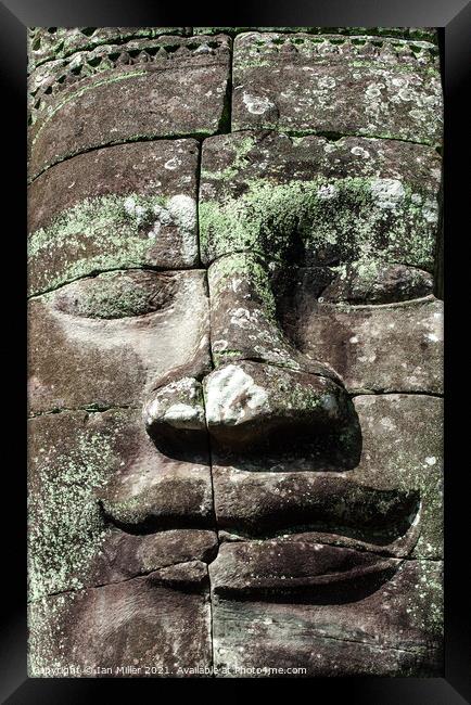 Stone face at Angkor Thom, Cambodia Framed Print by Ian Miller