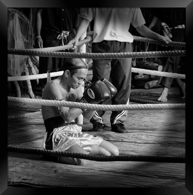 Muay Thai  boxer meditates before a bout. Bangkok, Thailand. Framed Print by Peter Bolton