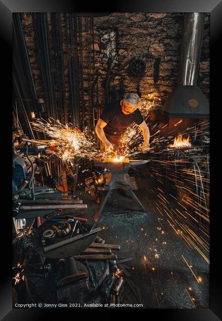 Sparks fly as metal is forged  Framed Print by Jonny Gios