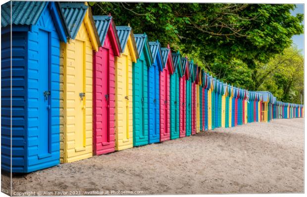 Brightly coloured beach huts at Llanbedrog, Wales. Canvas Print by Alan Taylor