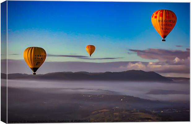 View of Hot Air Balloons over the countryside with Canvas Print by Maggie Bajada