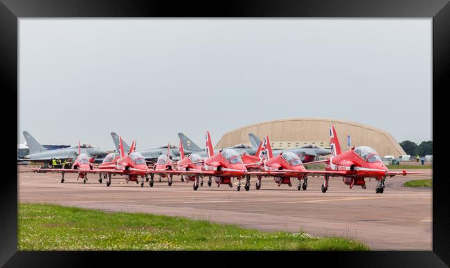 The Red Arrows hug a taxiway in front of four Typhoon's Framed Print by Jason Wells