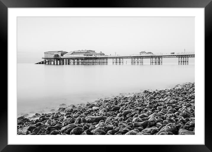 Cromer pier seen over the pebble beach in monochro Framed Mounted Print by Jason Wells