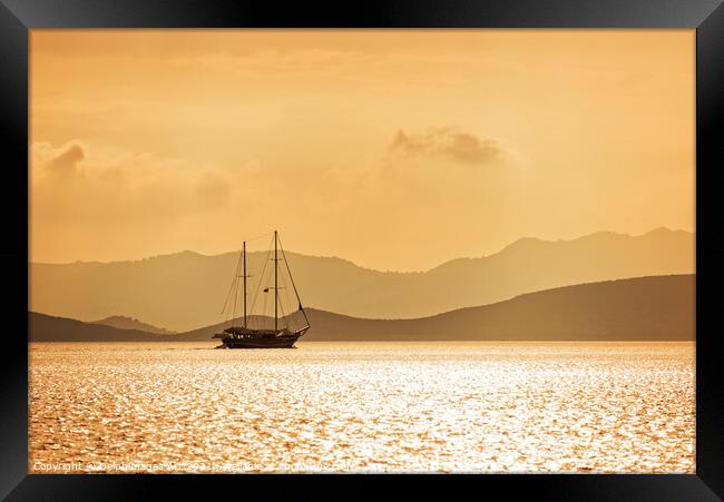 Sailing boat in gold at sunset Framed Print by Delphimages Art