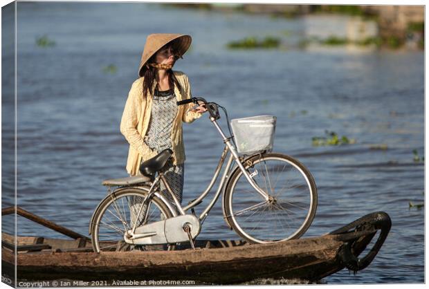 Bicycle and Girl on a WaterTaxi, Vietnam Canvas Print by Ian Miller