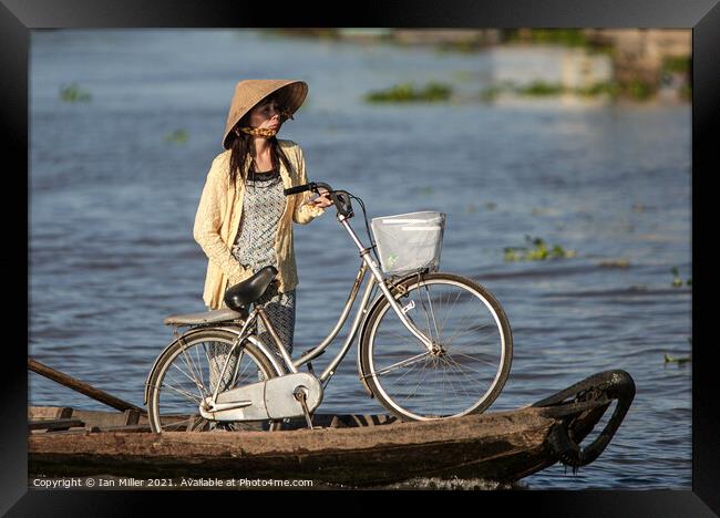 Bicycle and Girl on a WaterTaxi, Vietnam Framed Print by Ian Miller
