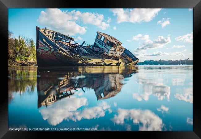 Wreck of a wooden fishing boat in the clouds Framed Print by Laurent Renault