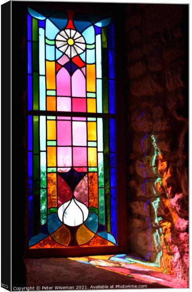 Radiant colours in a stained glass window Canvas Print by Peter Wiseman
