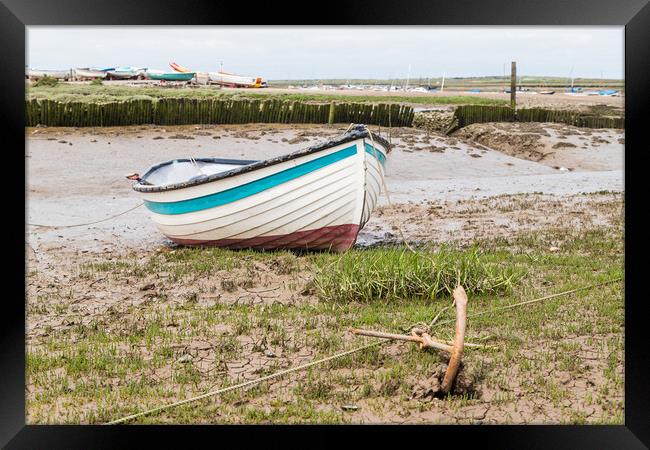 Boat anchored to the shore at Brancaster Staithe Framed Print by Jason Wells