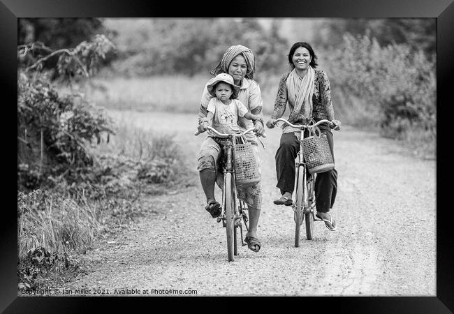 Bikes on a dirt road, Vietnam Framed Print by Ian Miller