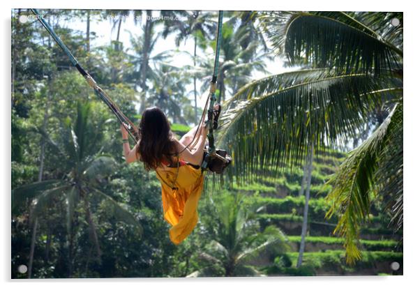 Young woman swinging in the jungle rainforest of Bali, Indonesia Acrylic by Yann Tang