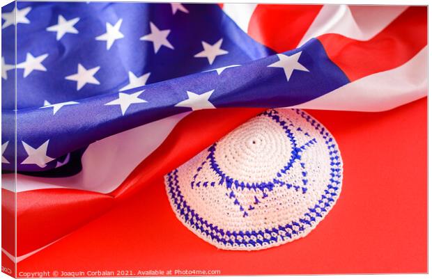 Jewish kipa under an American flag, isolated on red background Canvas Print by Joaquin Corbalan