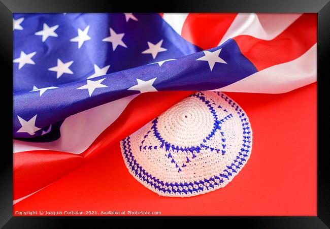 Jewish kipa under an American flag, isolated on red background Framed Print by Joaquin Corbalan