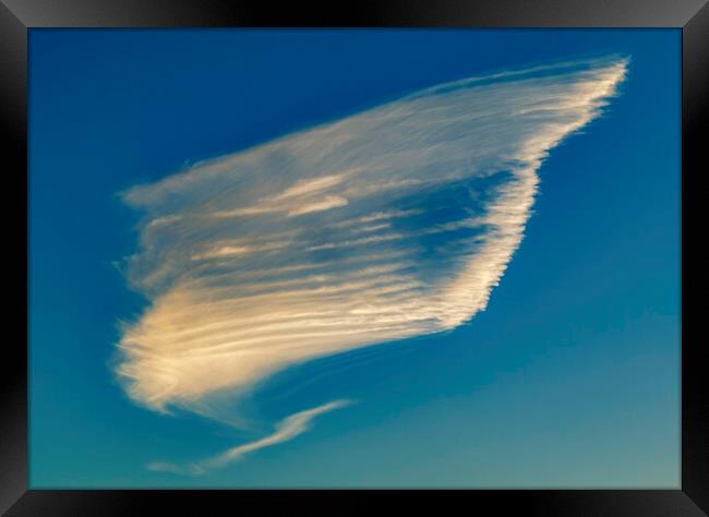 Cloud formation against a blue sky Framed Print by Rory Hailes