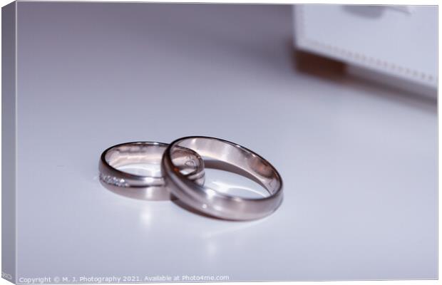 wedding rings isolated on white Canvas Print by M. J. Photography
