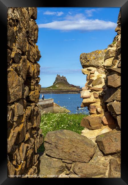 Lindisfarne Castle through the wall Framed Print by Jim Monk